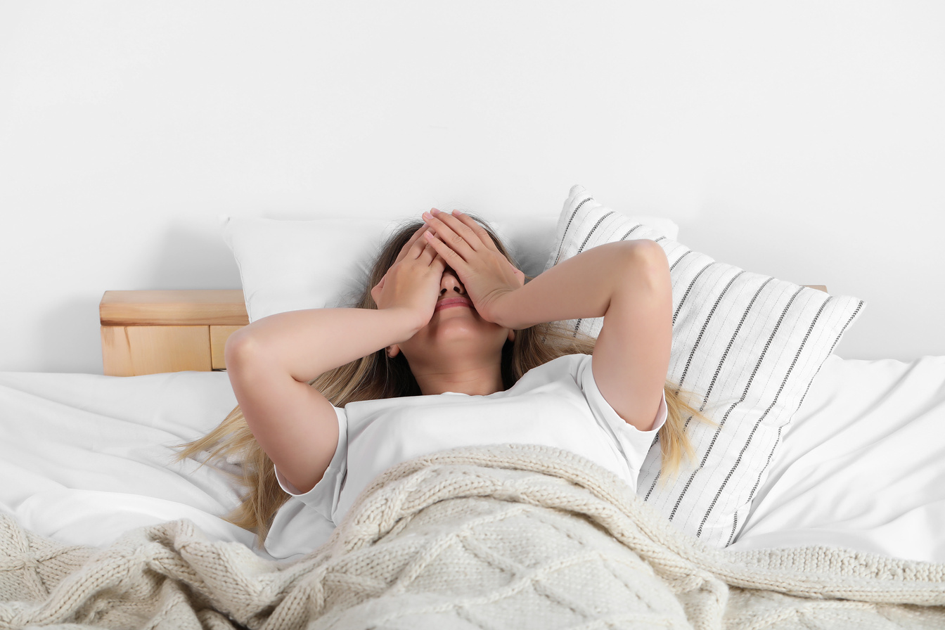 Sleepless Young Woman in Bed at Home