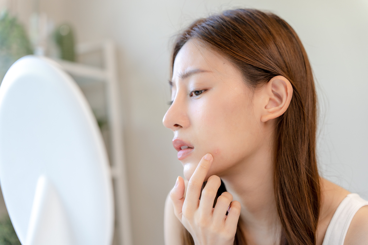 Girl Examining her Skin