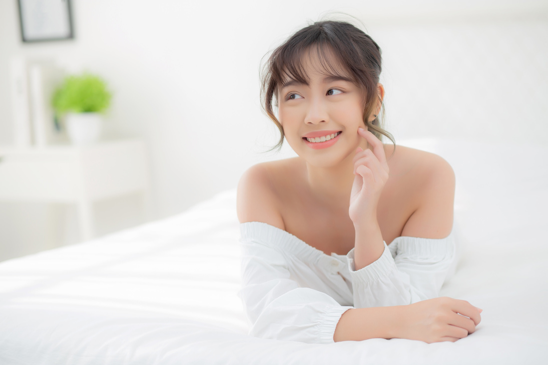 Portrait of a Woman Touching Her Face on the Bed